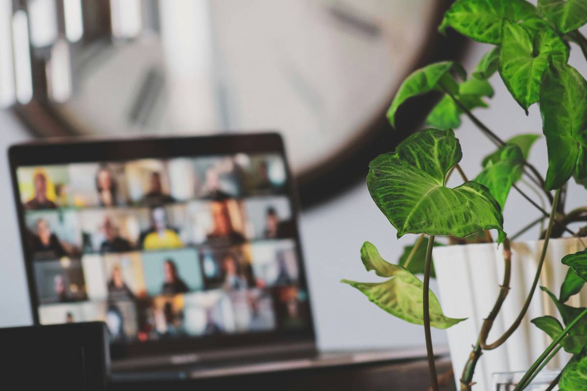 Business team using cloud phone system basics features like call forwarding and voicemail-to-email on laptops and smartphones